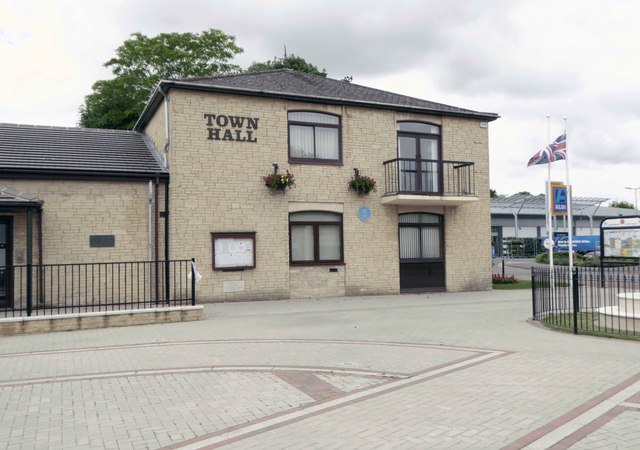 Exterior of the hall at 19 Alvescot Road, Carterton, with Aldi visible opposite.