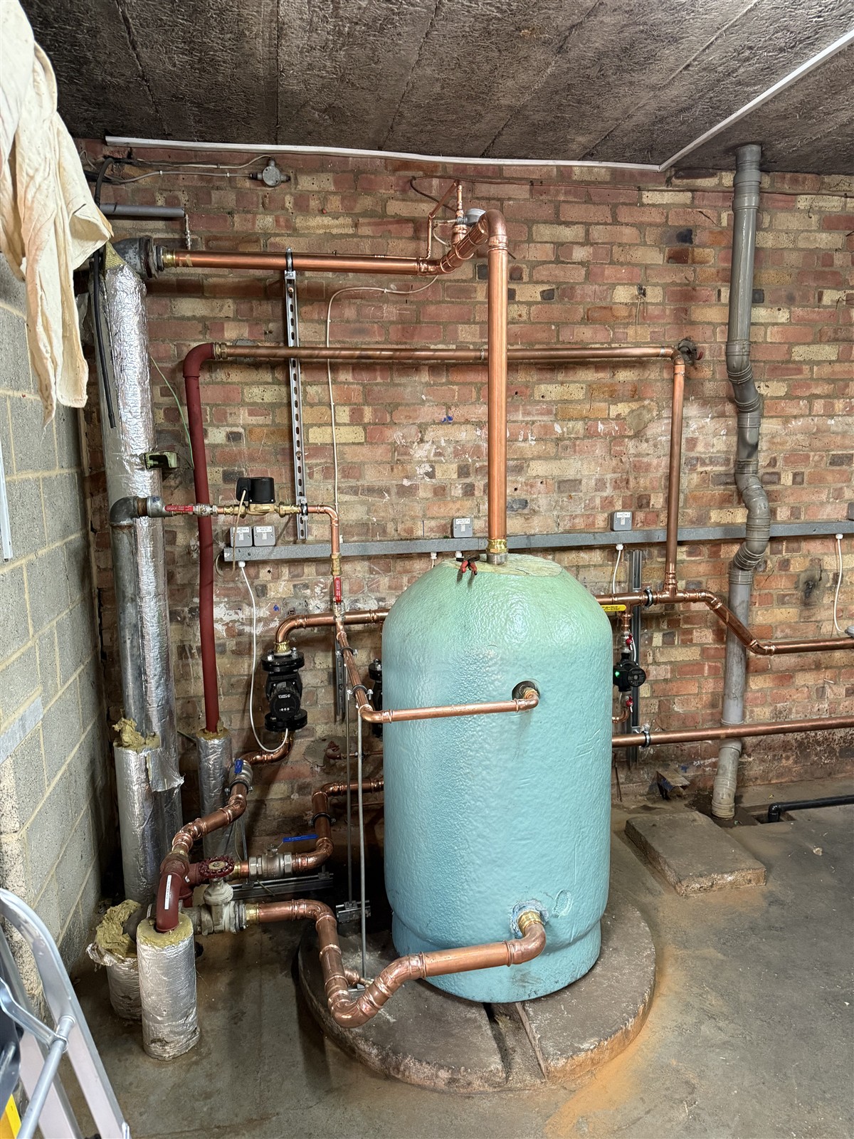 Copper pipework connected to a hot-water cylinder at Mulberry Bush School