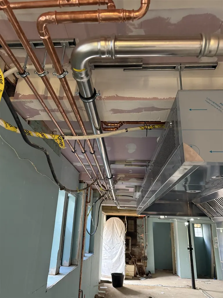 Stainless-steel gas main routed above the new Beaconsfield Golf Club commercial kitchen