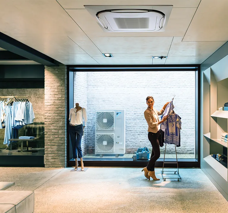 Daikin Sky Air ceiling cassette and outdoor unit illustrated in a shop