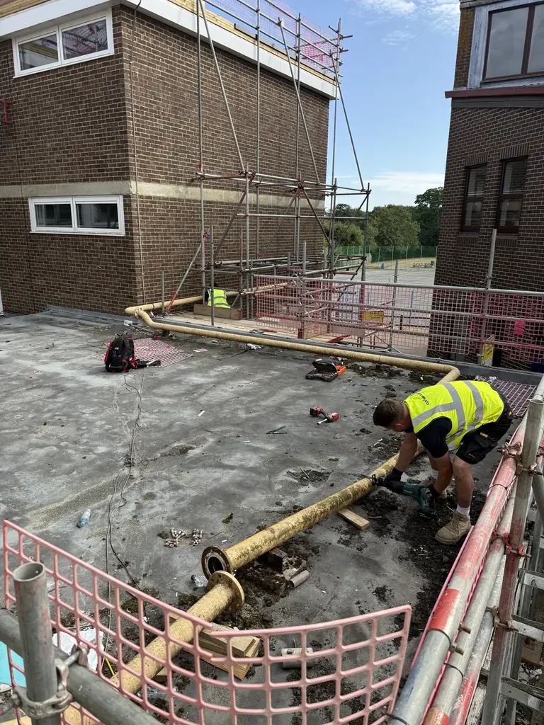 Existing low-carbon steel gas main crossing the roof at Faringdon Community College before removal