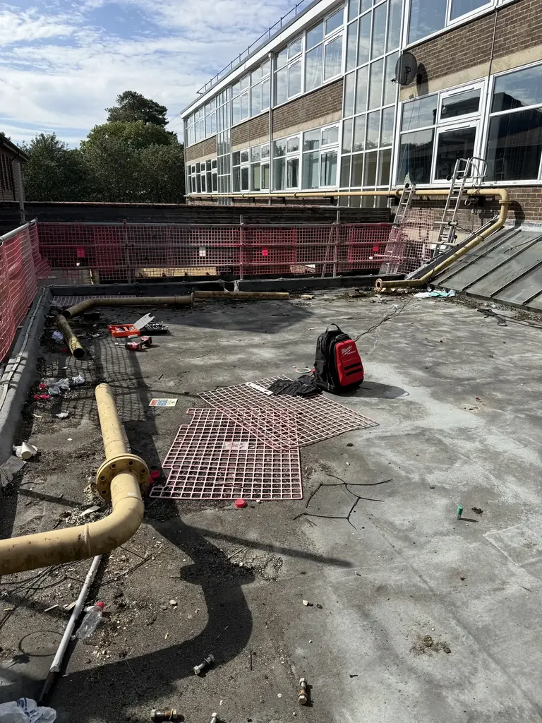 Original rooftop gas-main route at Faringdon Community College before replacement