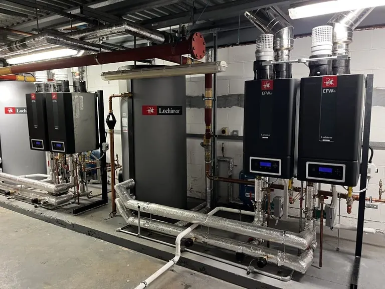 Lochinvar EcoForce water heaters, storage vessels and connected pipework in a school plant room