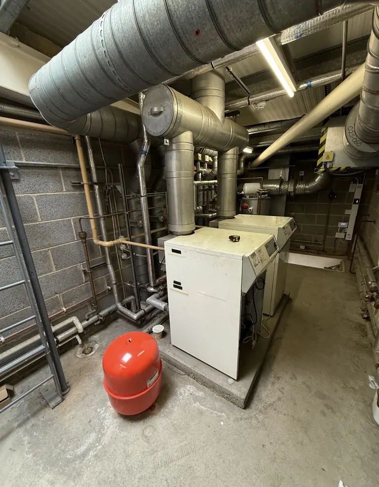 Existing floor-standing boilers and their flues at LTI Metaltech before removal