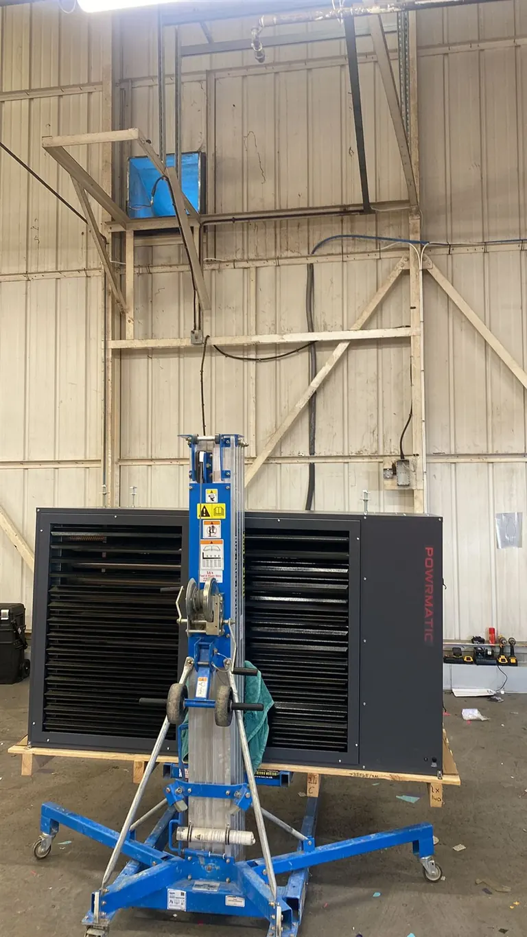 Material lift positioned to raise the new Powrmatic warehouse heater