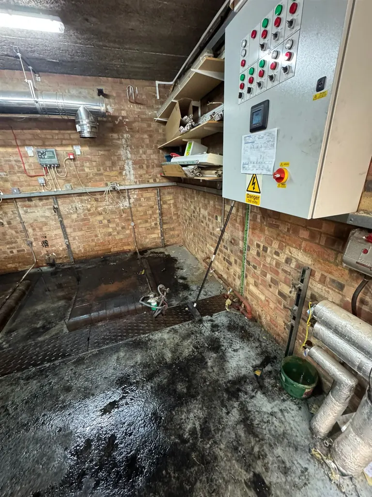 Cleared plant-room floor prepared for new equipment at Mulberry Bush School