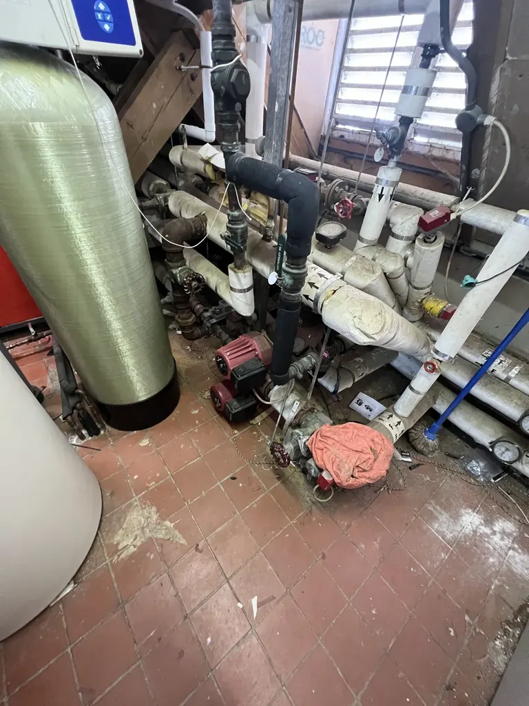Original Grundfos heating circulation pumps and ageing plant-room equipment at The Old Prebendal House