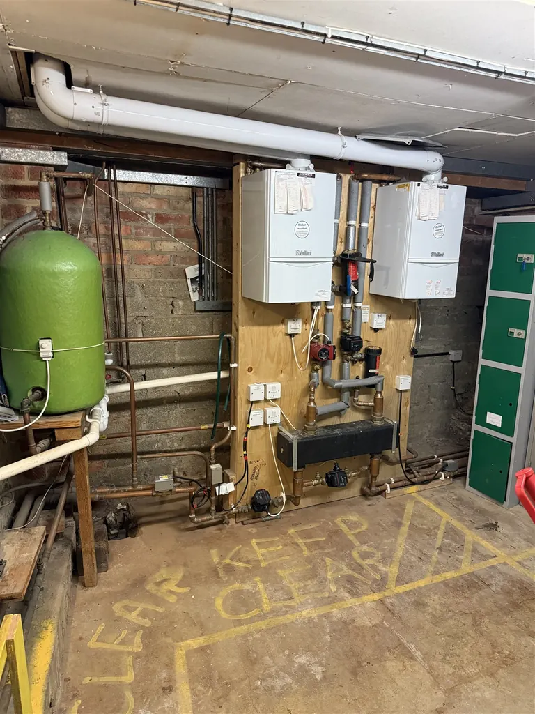 Two ageing Vaillant regular boilers and the original expansion equipment at the Vale and Downland Museum