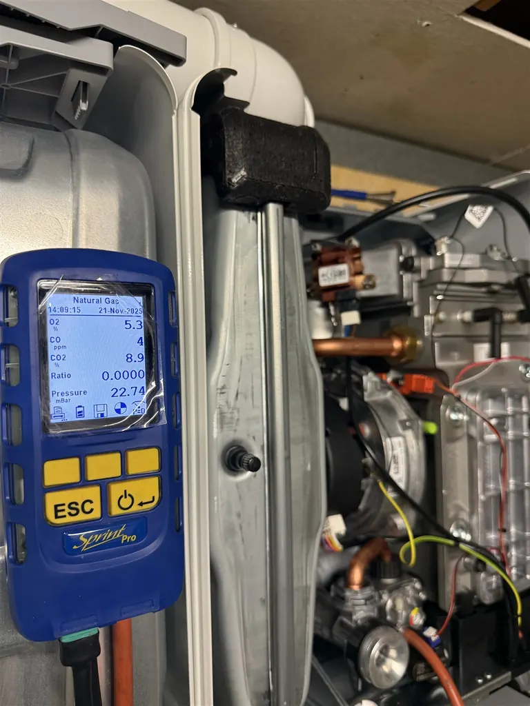 Combustion analyser connected during commissioning of a Worcester Bosch boiler at the museum