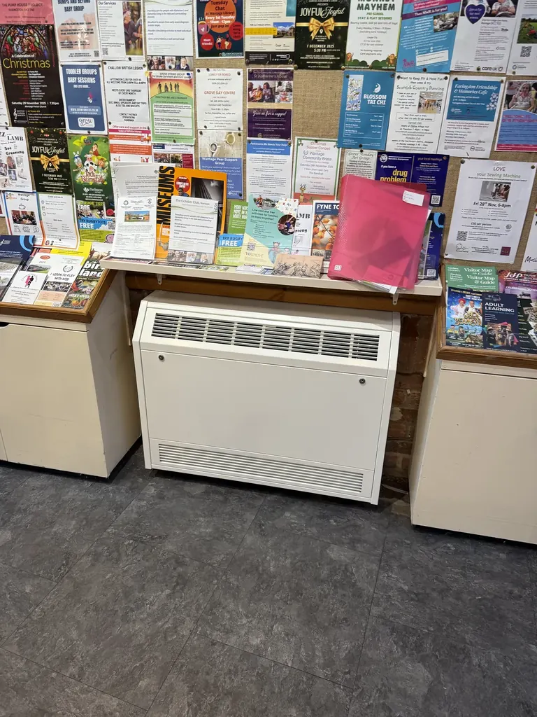 New enclosed room convector heater installed beneath the museum information display