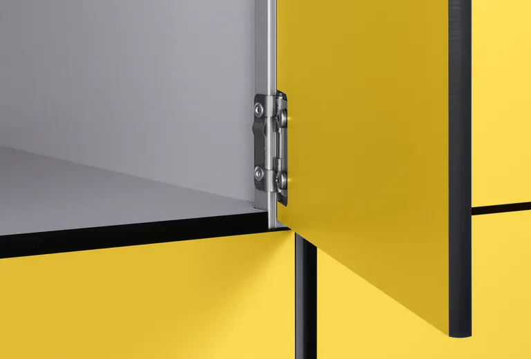 Yellow Venesta locker doors showing hinges and an open compartment