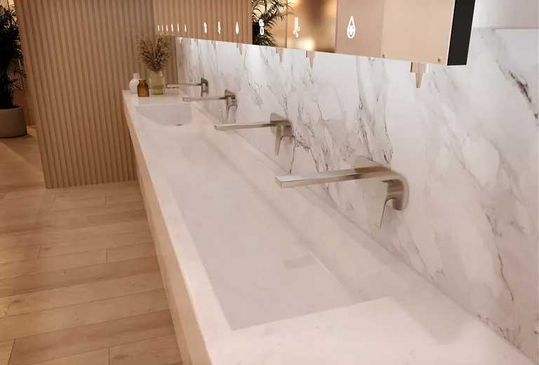 Venesta solid-surface washtrough with marble-effect splashback and multiple outlets