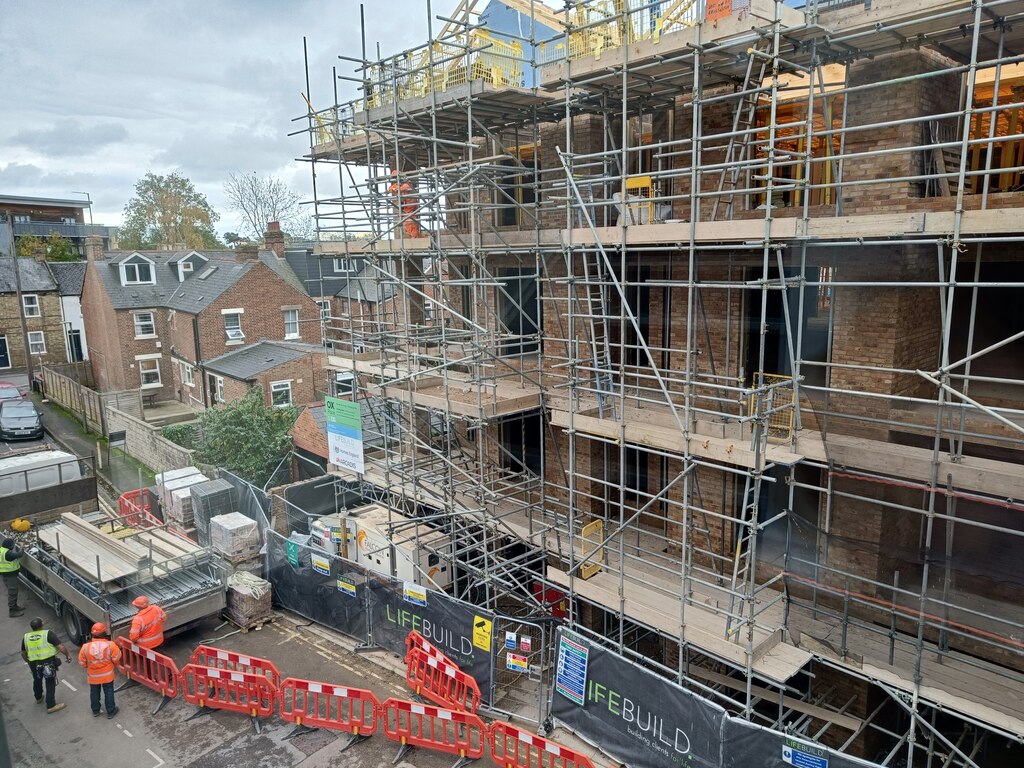 Scaffolding around a brick apartment building under construction in Oxford.