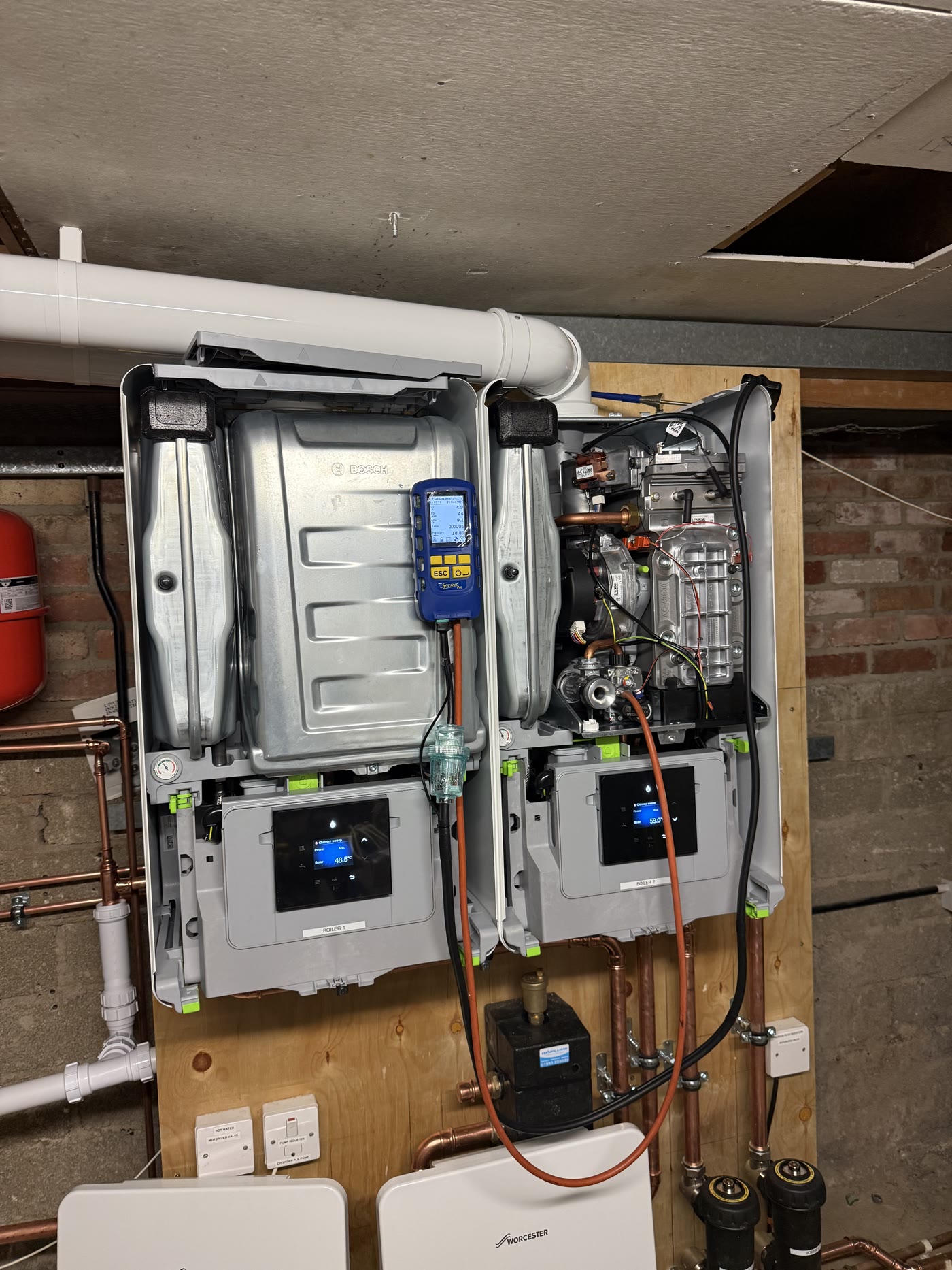 Twin Worcester commercial boilers opened for combustion analysis and servicing