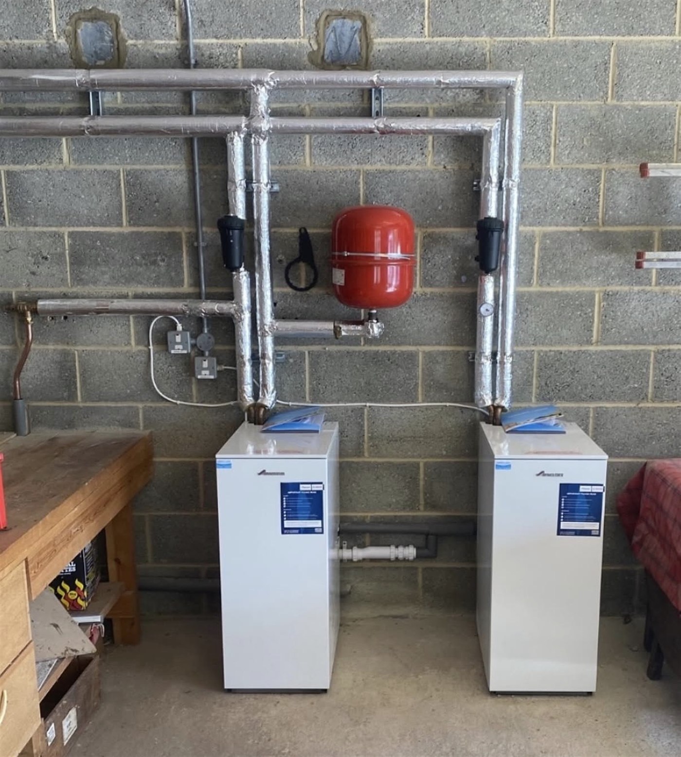 Twin floor-standing Worcester heating appliances with insulated pipework and expansion vessel